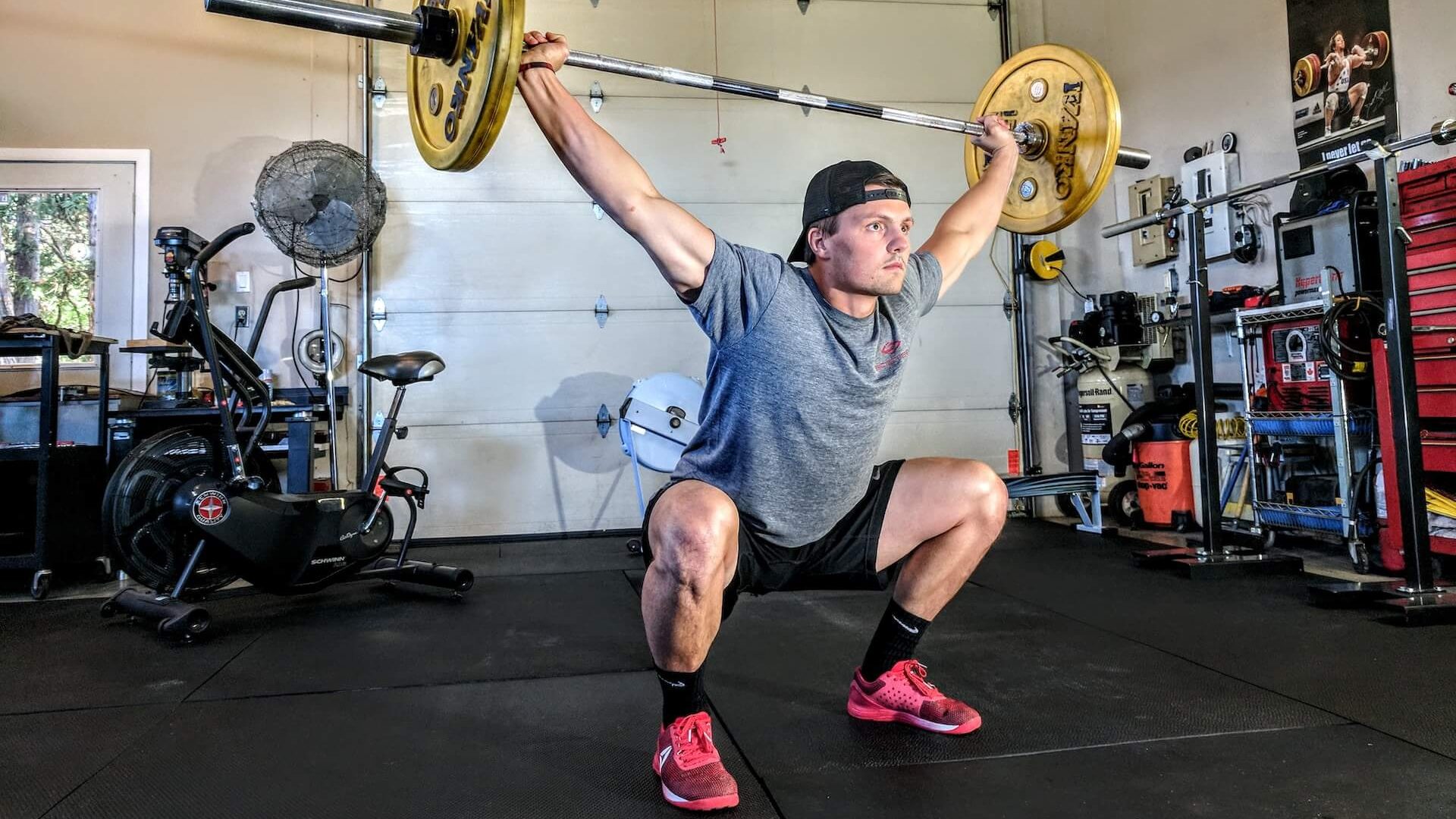 Alt text for an image of an athlete performing a snatch, an Olympic weightlifting movement.